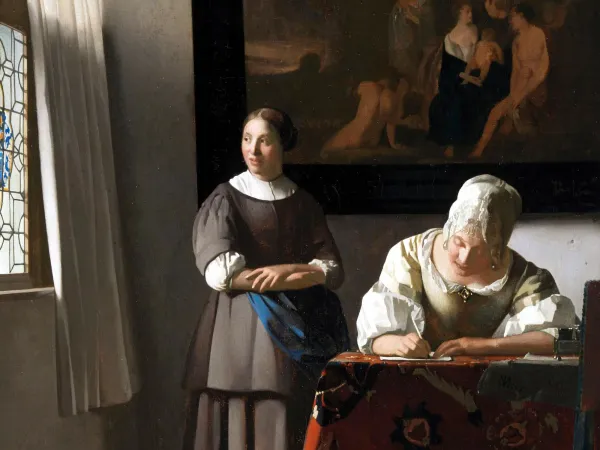 An oil painting of two women at a desk. One of them is writing.